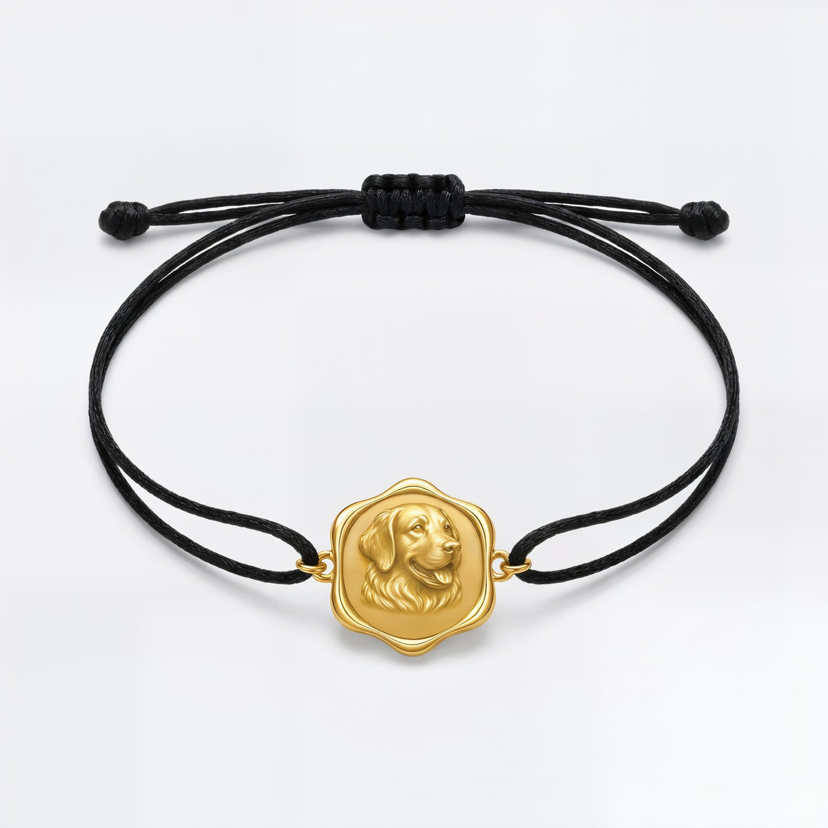 The bracelet medallion on its black polyester cord