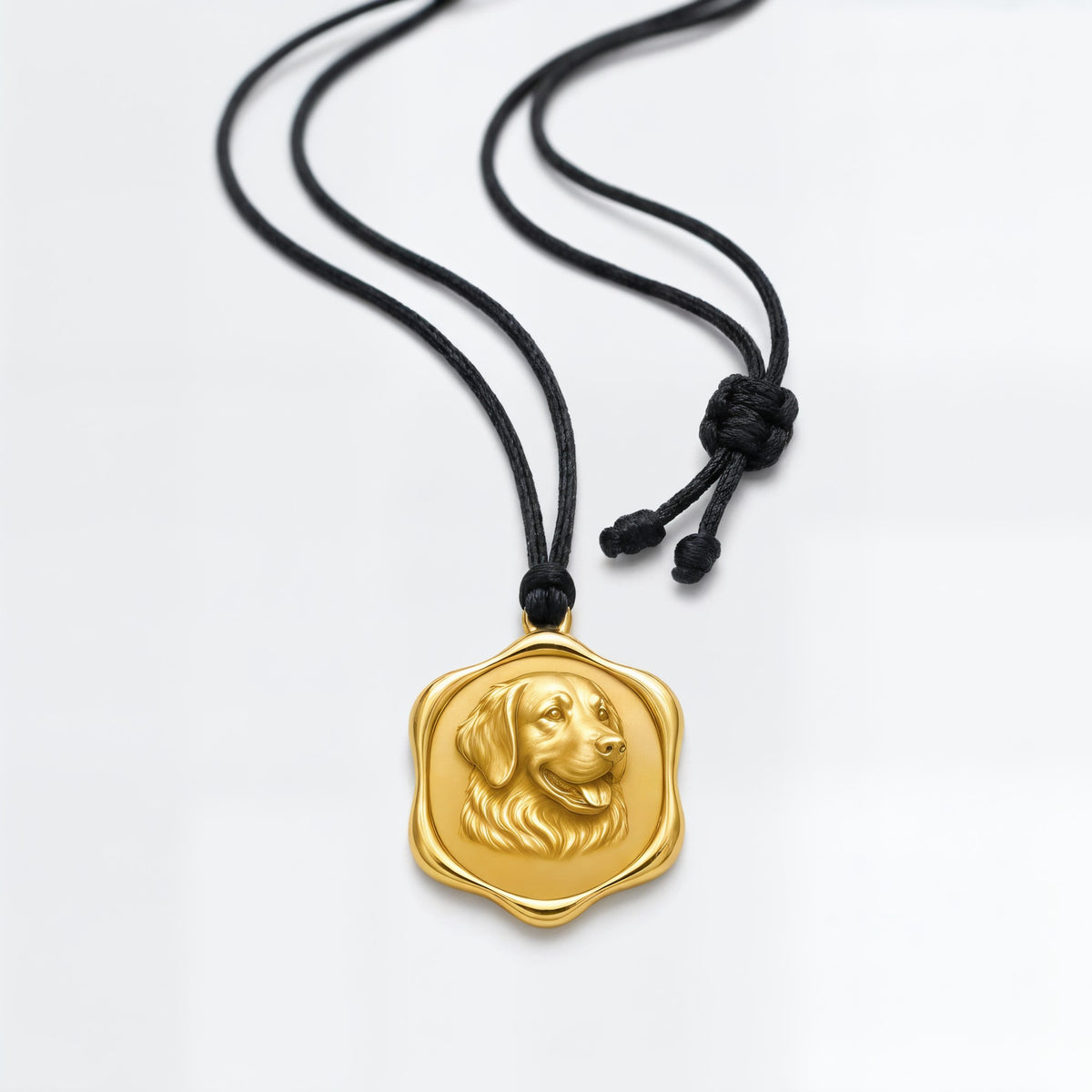 The portrait medallion on its black polyester cord with a sliding knot